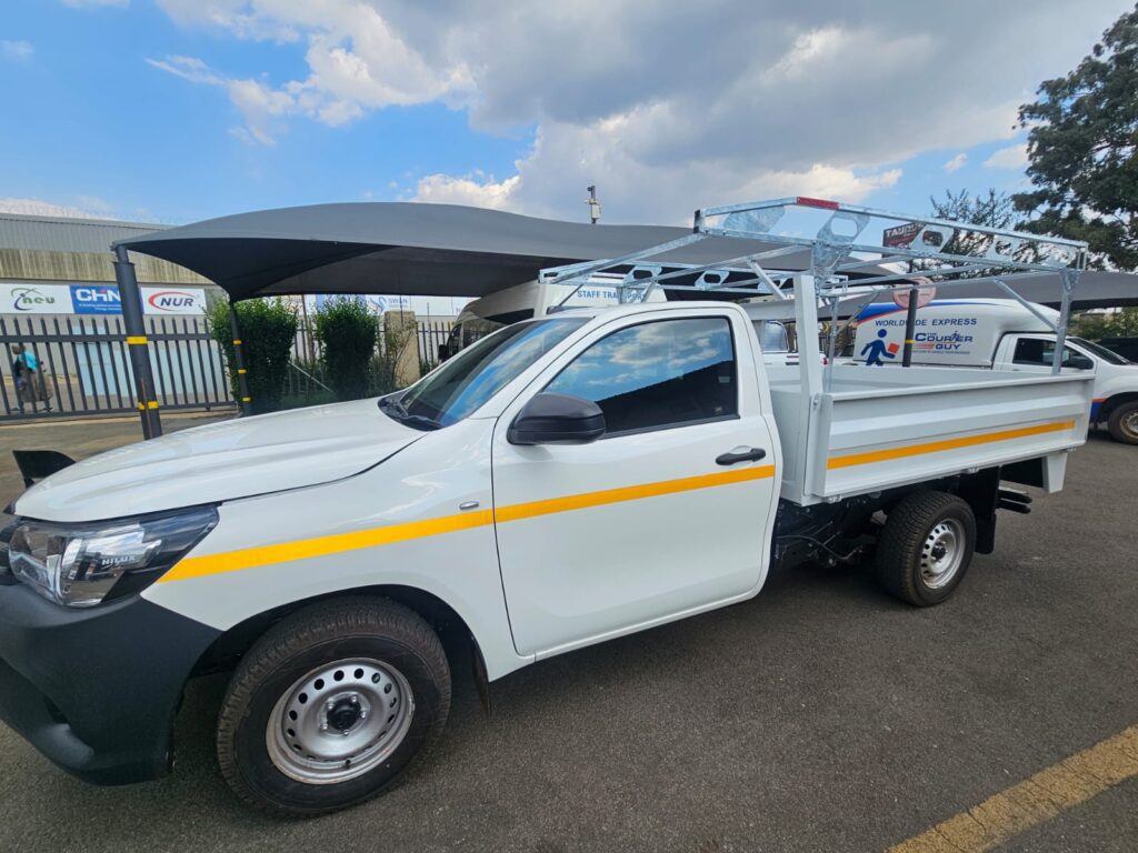 White utility truck with ladder rack