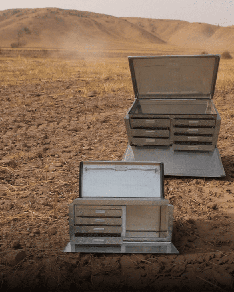aluminium toolboxes in the kalahari against a sunset